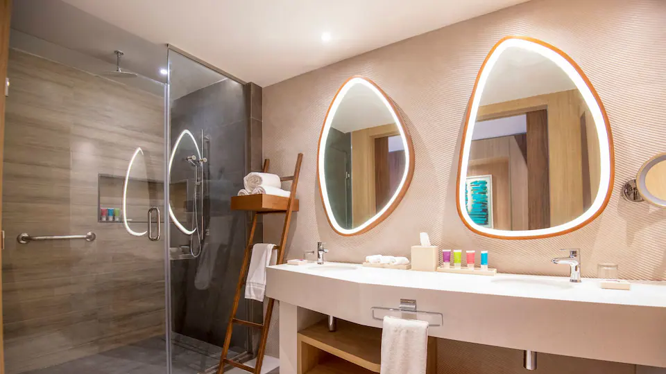 Club Junior Suite Swim-Up Double bathroom with walk-in rain shower and double vanity at Hyatt Ziva Cap Cana.