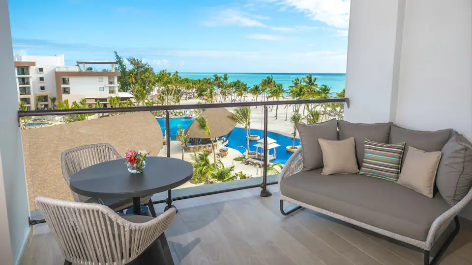 Private balcony with ocean and pool views from the Club Ocean View Junior Suite Double at Hyatt Ziva Cap Cana.
