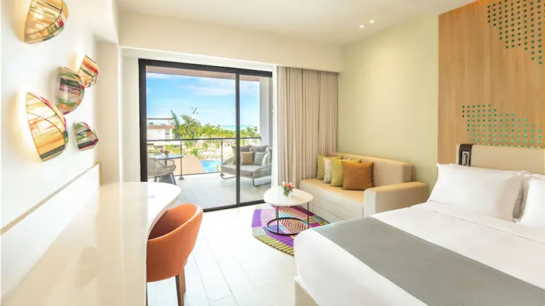 Club Ocean View Junior Suite Double living area with sofa and ocean-view balcony at Hyatt Ziva Cap Cana.