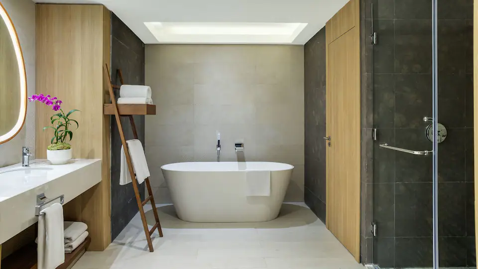 Spacious bathroom with freestanding soaking tub and walk-in shower in the Club Ocean View One Bedroom Grand Master Suite at Hyatt Ziva Cap Cana.
