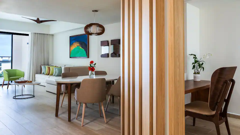Dining area and living room inside the Club Ocean View One Bedroom Grand Master Suite at Hyatt Ziva Cap Cana.