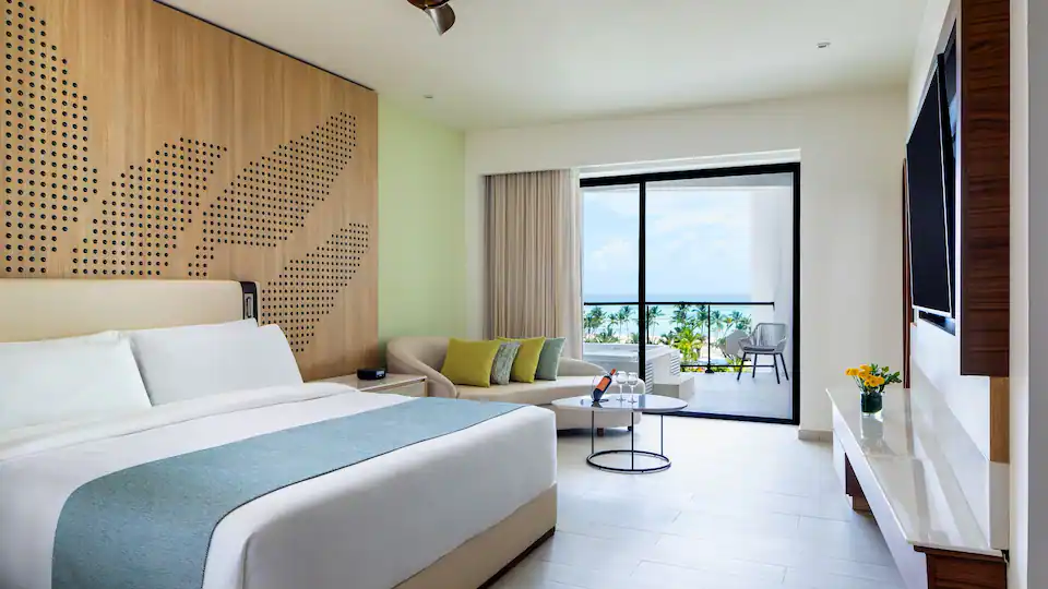 King bedroom with balcony access and ocean views in the Club Ocean View One Bedroom Grand Master Suite.