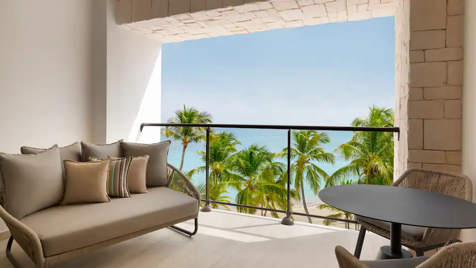 Private oceanfront balcony with seating at the Club Oceanfront Junior Suite King at Hyatt Ziva Cap Cana.