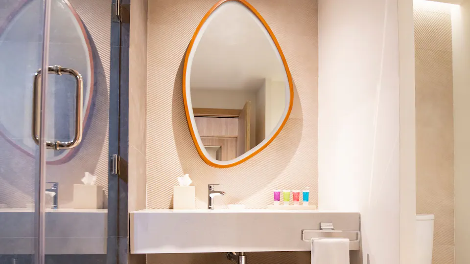 Modern vanity with illuminated mirror in the Club One Bedroom Master Suite bathroom at Hyatt Ziva Cap Cana.