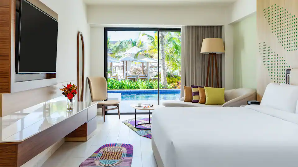 Club One Bedroom Master Swim-Up Suite bedroom at Hyatt Ziva Cap Cana with elegant décor, king bed, and direct swim-up pool access.