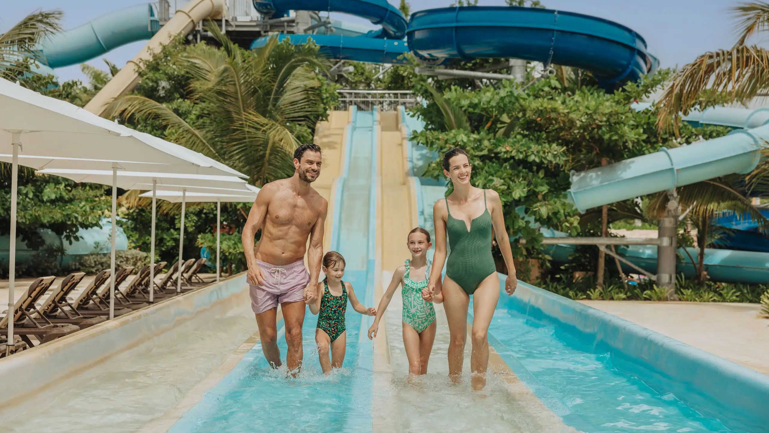 Family enjoying the lazy river and water slides at Canapolis Water Park at Hyatt Ziva Cap Cana, a top family-friendly resort in Punta Cana.