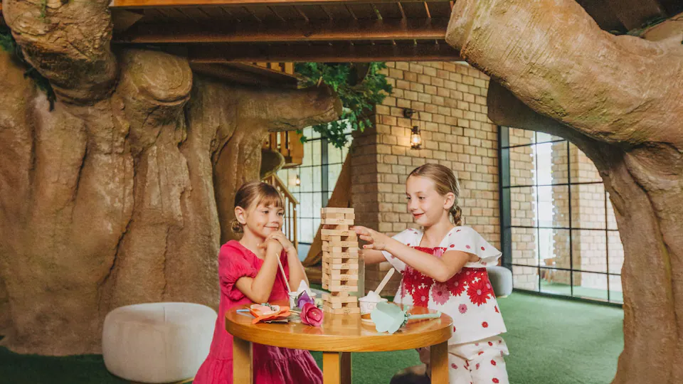 Children playing games inside the kids club at Hyatt Ziva Cap Cana, offering supervised activities and family-friendly entertainment.