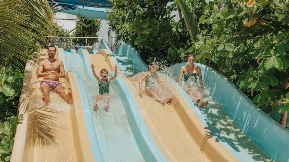Family enjoying water slides at Canapolis Water Park at Hyatt Ziva Cap Cana, one of Punta Cana’s top family-friendly resort attractions.
