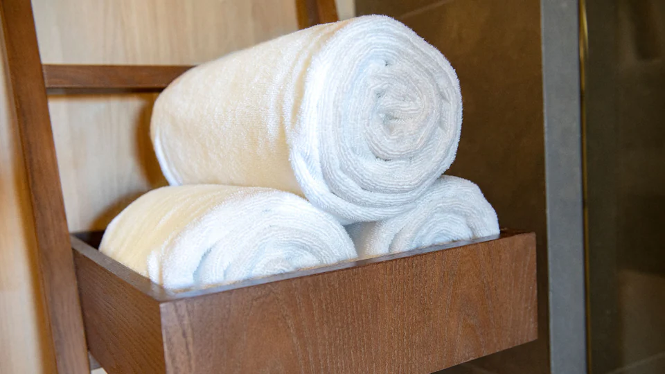 Plush rolled bath towels and bathroom amenities in the Junior Suite King at Hyatt Ziva Cap Cana.