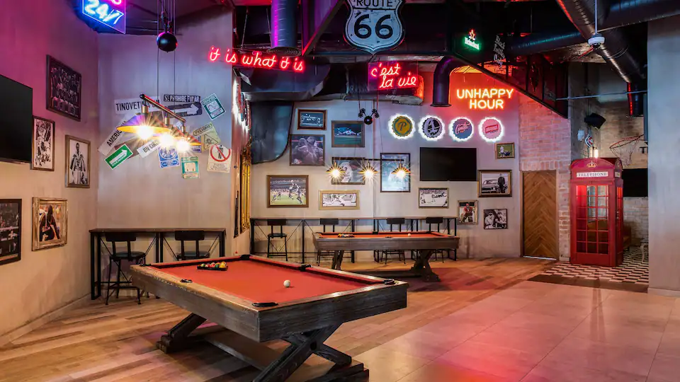Moments Sports Lounge at Hyatt Ziva Cap Cana featuring multiple flat-screen TVs, contemporary seating, and a lively atmosphere for watching live sporting events.