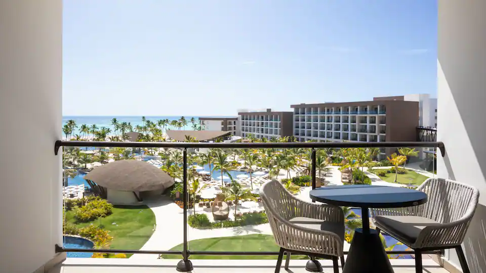 Ocean View Junior Suite Double balcony seating area with views of Hyatt Ziva Cap Cana and the Caribbean Sea.