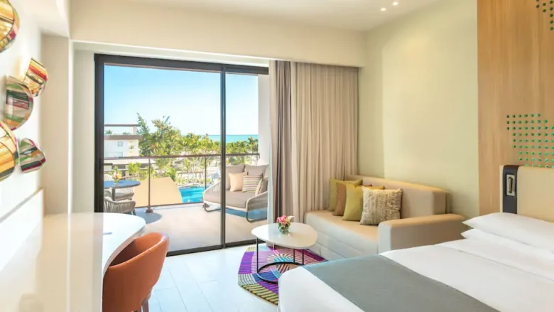 Ocean View Junior Suite Double with two queen beds, sitting area, and private balcony at Hyatt Ziva Cap Cana.