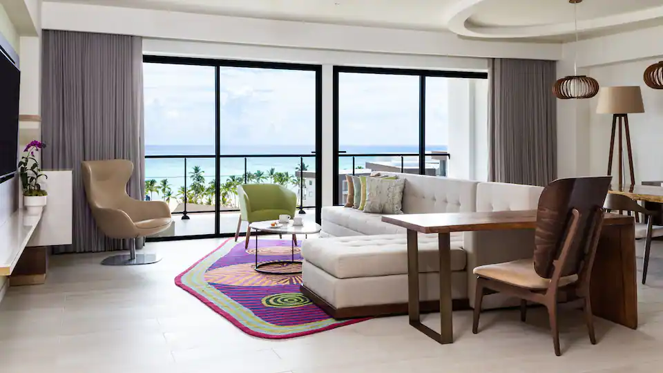 Spacious living room with ocean-view balcony access in the Presidential Suite at Hyatt Ziva Cap Cana.
