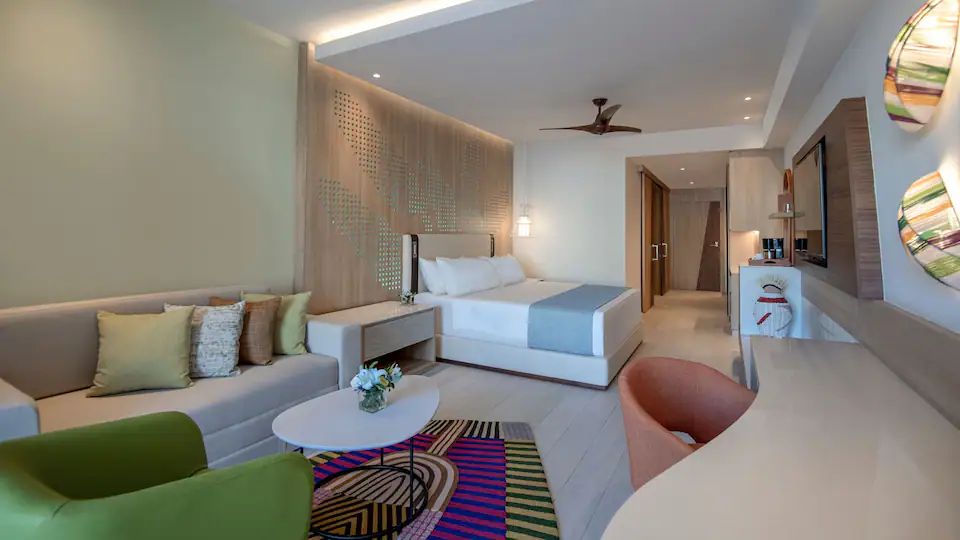 Resort View Junior Suite King with king bed, sleeper sofa, and contemporary furnishings at Hyatt Ziva Cap Cana.